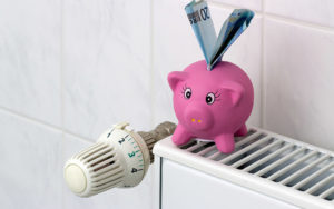 Piggy Bank With Radiator Thermostat Saving Heating Costs