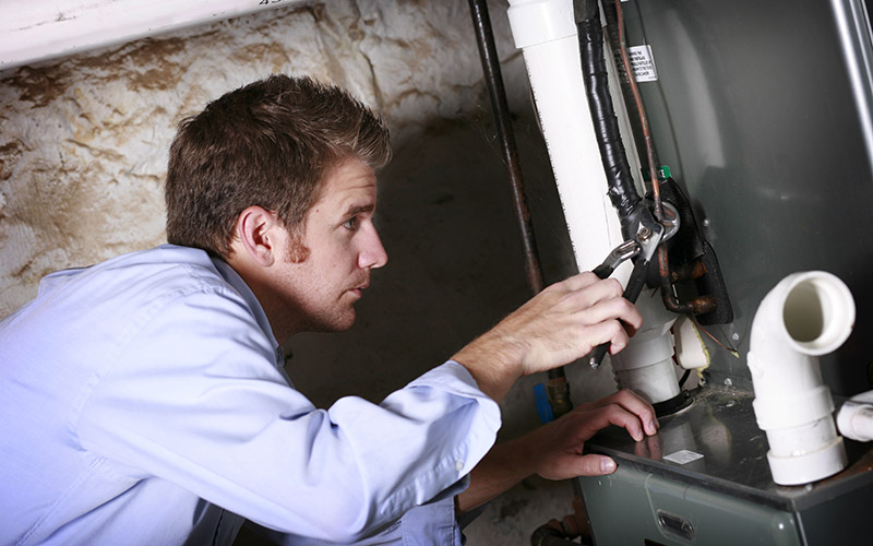 service tech working on a furnace