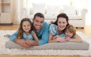 Happy Family Laying On Floor