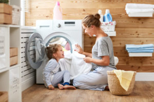 Child And Mom Doing Laundry