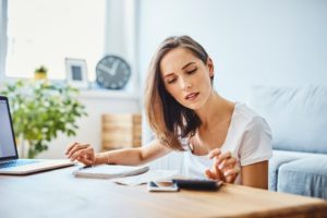 Woman Looking At Calculator