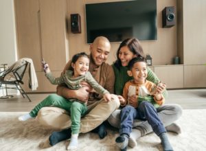 Happy Family Playing On Living Room Floor