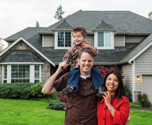 Couple And Son Stand Outside Beautiful Home Sm