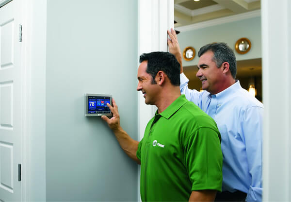 Trane Tech Showing Customer How To Use Smart Thermostat